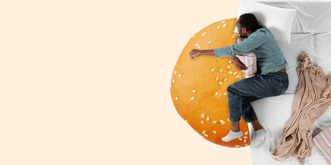 Fast food. Portrait of a young man sleeping in comfortable bed and dreaming about burger. Top view. Sweet dreams. Concept of food and drinks, phycology, humor. Copyspace for your ad. Artwork.