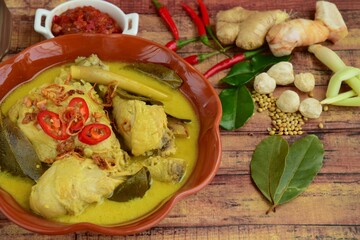 Opor ayam, chicken cooked in coconut milk from Indonesia, from Central Java, served with sambal. Popular dish for lebaran or Eid al-Fitr