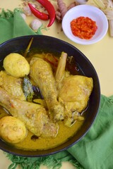 Opor ayam, chicken cooked in coconut milk added with boiled eggs. Originated from Central Java, Indonesia, served with sambal. Popular dish for lebaran or Eid al-Fitr