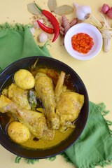 Opor ayam, chicken cooked in coconut milk added with boiled eggs. Originated from Central Java, Indonesia, served with sambal. Popular dish for lebaran or Eid al-Fitr