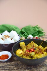 Opor ayam, chicken cooked in coconut milk from Indonesia, from Central Java, added with boiled eggs, served with lontong and sambal. Popular dish for lebaran or Eid al-Fitr