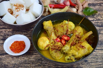 Opor ayam, chicken cooked in coconut milk from Indonesia, from Central Java, added with boiled eggs, served with lontong and sambal. Popular dish for lebaran or Eid al-Fitr