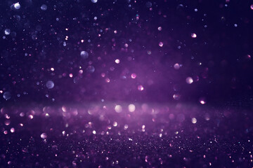 background of abstract glitter lights. black and purple. de focused