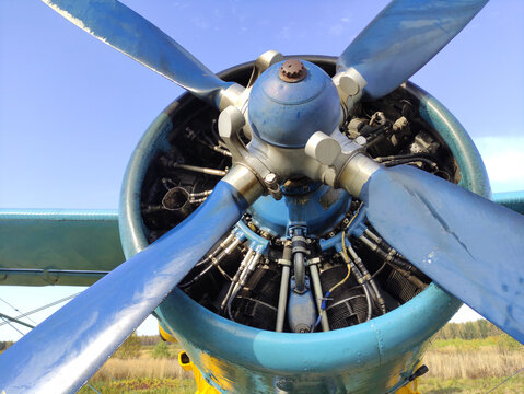 Piston Engine Of An Old Biplane Plane With A Blue Propeller Close Up