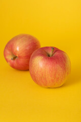 red apples on a yellow table