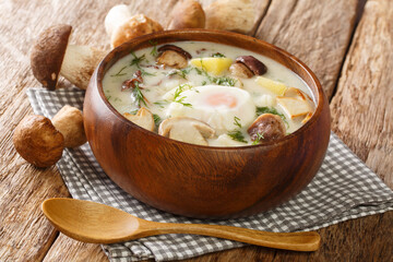 Czech Kulajda Creamy Mushroom Soup close-up in a bowl on the table. Horizontal