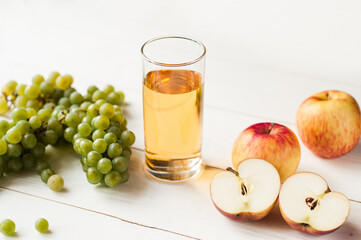 fresh grape fruits with green leaves isolated on white background. bunch of green grapes and juice in the glass, pitcher.