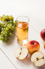 fresh grape fruits with green leaves isolated on white background. bunch of green grapes and juice in the glass, pitcher.