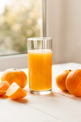 Glass of 100% Orange juice with pulp and sliced fruits isolate on white background.Be cut to remove...