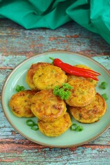 Perkedel, Indonesian fried potato minced beef patties garnish with parsley and chili in a bowl 