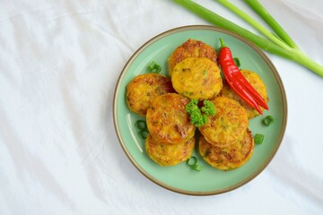 Perkedel, Indonesian fried potato minced beef patties garnish with parsley and chili in a bowl 