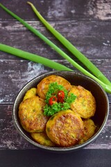 Perkedel, Indonesian fried potato minced beef patties garnish with parsley and chili in a bowl on...