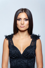 Naklejka premium Frontal portrait of a beauty studio portrait of beautiful woman with long straight hair and bright makeup.