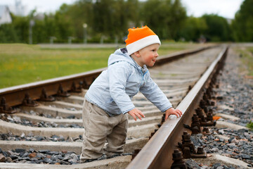 dangerously. little boy on the train tracks
