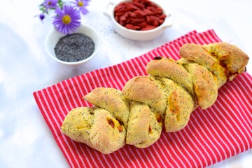 Fresh baked French pain d'epi or wheat stalk bread with goji berry and poppy seeds
