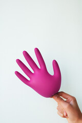 Inflated crimson protective gloves isolated on white, top view. Medical subject
