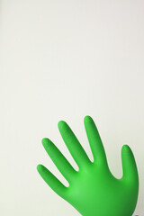 Fototapeta na wymiar Protective gloves of green color isolated on white, top view. Medical subject 