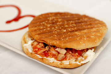 Round tuna and tomatoes sandwich, bread and fish toast