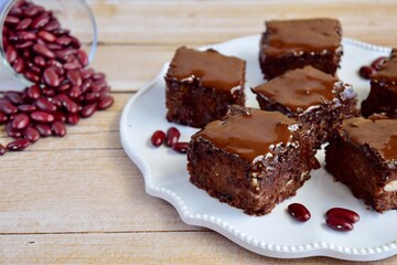 Kidney bean chocolate brownies. Vegan and gluten free. Wooden background