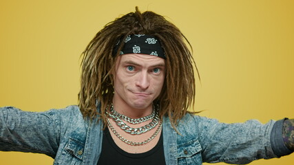 Stylish rocker in headband pointing hands on himself. Man gesturing with hands
