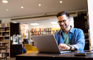 Happy man working on laptop. Technology people work study concept