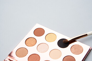 eyeshadow makeup brushes collection professional cosmetics accessories beads on gray background