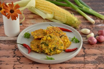 Perkedel jagung or bakwan jagung, corn fritters with red chili. Indonesian cuisine.
