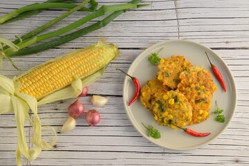 Perkedel jagung or bakwan jagung, corn fritters with red chili. Indonesian cuisine.
