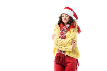 young freezing woman in santa hat and scarf standing isolated on white