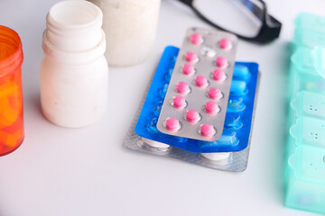 blister pack, container and pills on white background 