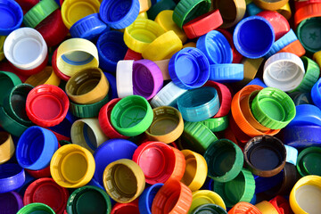Plastic bottle caps background. Cap material is recyclable.Remove lids from plastic bottles before recycling them. Recycling collection and processing plastic bottle caps