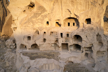Ancient cliff homes at Cappadocia, Turkey. Fascinating cave dwellings carved into rock formations. Travel to Turkey.