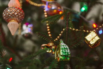 Classic traditional holiday toys on a real live green Christmas tree