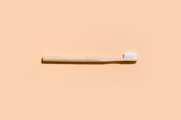 Toothbrush on camel color background. Zero Waste Home. Top view