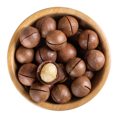 Macadamia nuts in wooden bowl isolated on white. Top view.