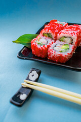Set of sushi and maki on a blue background. Top view with copy space