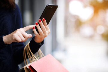 business woman holding hand many shopping bag in fashion boutique to shopping Convenient instant. Customers can use the mobile phone to shopping online Order purchase Sell and Payment transfer money.