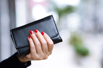 woman person holding a wallet in the hand. Cost control expenses shopping in concept. Leave space...