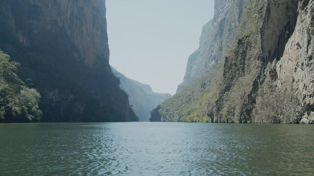 Navigating on a boat across the Grijalba River between the high mountains of the Sumidero Canyon in Mexico