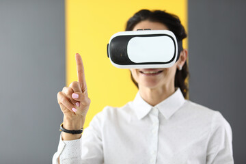 Woman is wearing virtual glasses she holds her thumbs up. Virtual reality glasses and their use concept