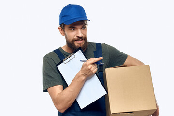 Working male courier with box in hand documents delivery service light background