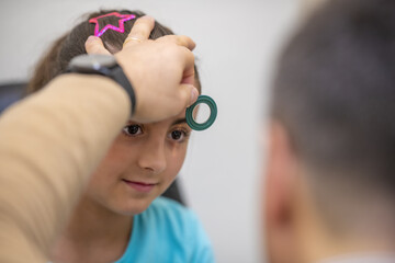 Young girl visited by ophthalmologist