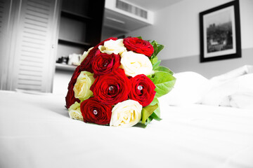 Red and White Roses Bouquet on a Bed in Isolated Colour 