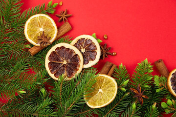 Fototapeta na wymiar Dry orange slices with christmas tree branches and spices