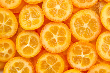 kumquat citrus fruit slices background