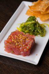 Tuna tartare. Classic American restaurant or bistro appetizer classic. Sushi grade ahi tuna, diced, mixed w/ eggs, red onions, olive oil, lemon juice, garlic & capers. Served w/ garlic bread.