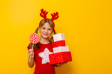 Little girl holding pile of Christmas gifts