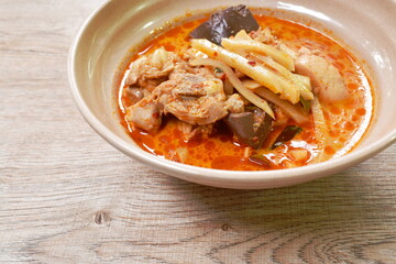 spicy boiled slice fresh bamboo shoot with chicken and blood in coconut milk curry soup on bowl