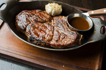 Steak. Grass-fed skirt steak, grilled to a medium rare and served with a garlic herb butter sauce and paired with roasted potatoes and Brussels sprouts. Classic American steakhouse favorite.