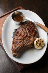 Steak. Grass-fed skirt steak, grilled to a medium rare and served with a garlic herb butter sauce and paired with roasted potatoes and Brussels sprouts. Classic American steakhouse favorite.